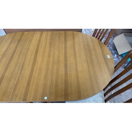 127 - A mid 20th century teak effect and beech drop leaf gate leg dining table and four fabric upholstered... 