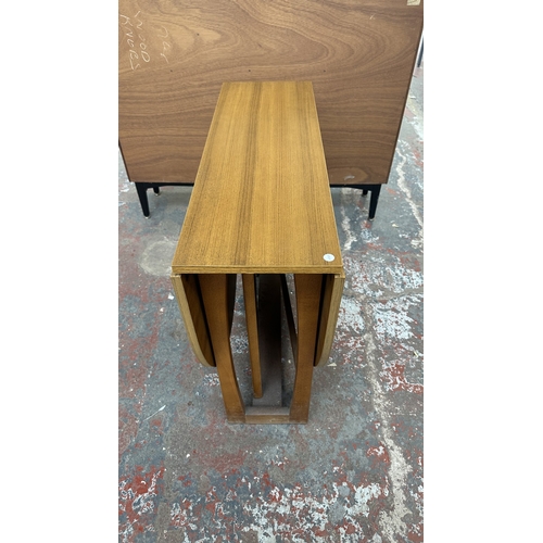 127 - A mid 20th century teak effect and beech drop leaf gate leg dining table and four fabric upholstered... 