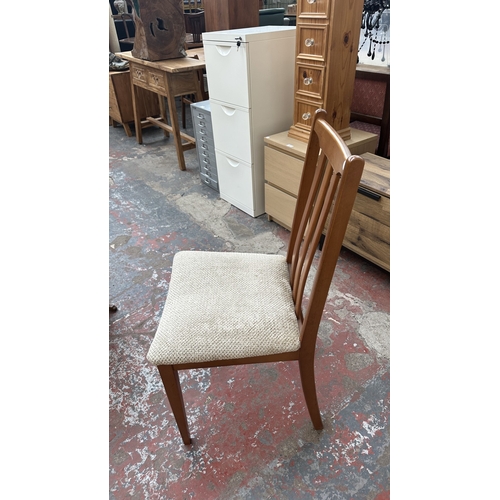 127 - A mid 20th century teak effect and beech drop leaf gate leg dining table and four fabric upholstered... 