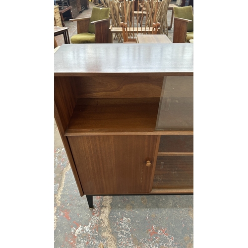 129 - A mid 20th century Nathan teak and ebonised bookcase with four glass sliding doors - approx. 98cm hi... 