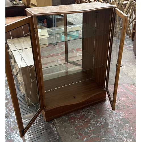 131 - A teak glazed two door display cabinet with two glass shelves - approx. 108cm high x 74cm wide x 33c... 