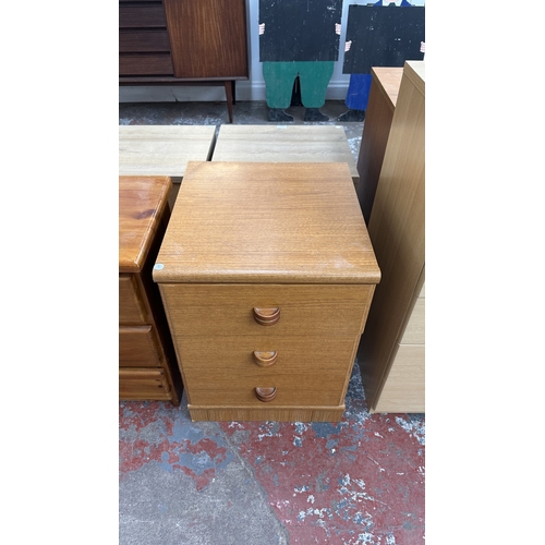 132 - Two bedside chests of drawers, one pine and teak effect - largest approx. 61cm high x 44.5cm wide x ... 