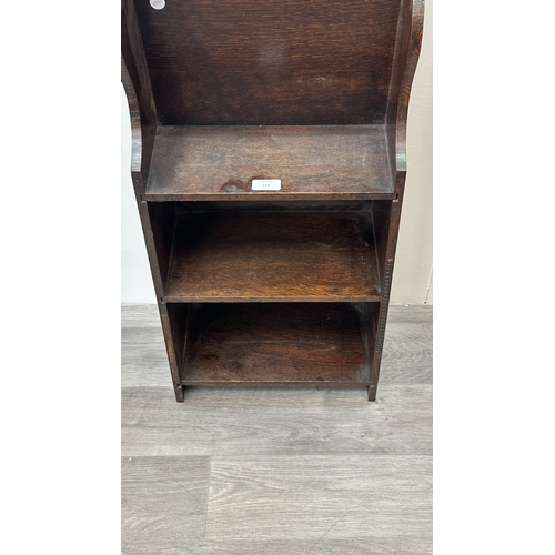 133 - An early 20th century oak three tier magazine rack bookcase - approx. 79cm high x 36cm wide x 20cm d... 