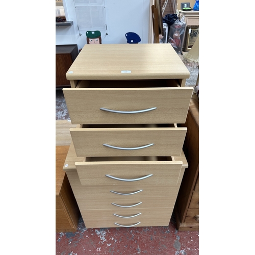 134 - A modern beech effect two piece bedroom suite comprising chest of drawers - approx. 87cm high x 72cm... 