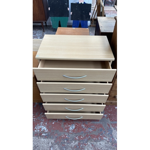 134 - A modern beech effect two piece bedroom suite comprising chest of drawers - approx. 87cm high x 72cm... 