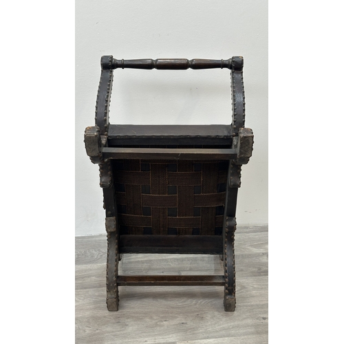 138 - A 1930s/40s leather and brass studded X-frame stool with turned beech handles and fabric upholstered... 