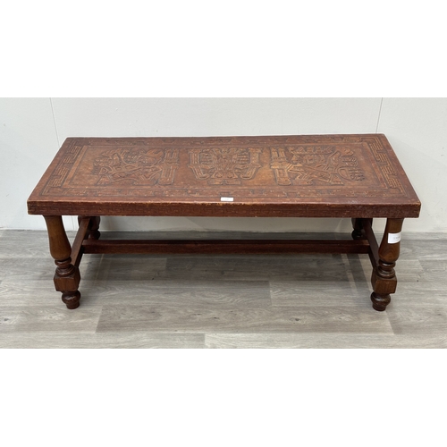 139 - A mid 20th century Peruvian hand-tooled leather and hardwood coffee table, attributed to Angel Pazmi... 