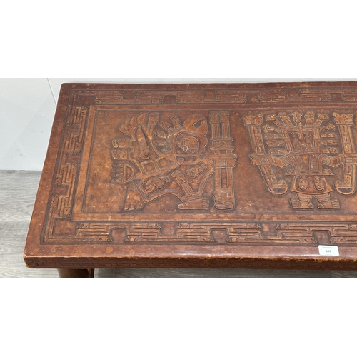 139 - A mid 20th century Peruvian hand-tooled leather and hardwood coffee table, attributed to Angel Pazmi... 