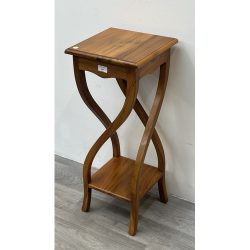 140 - An Indonesian teak jardinière/plant stand - approx. 75cm high x 36cm wide x 30cm deep