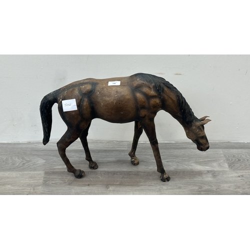 142 - A Liberty & Co. style leather model of a grazing horse - approx. 39cm high x 59cm long