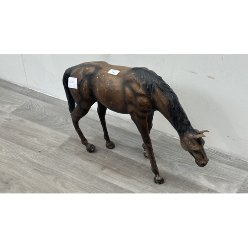 142 - A Liberty & Co. style leather model of a grazing horse - approx. 39cm high x 59cm long