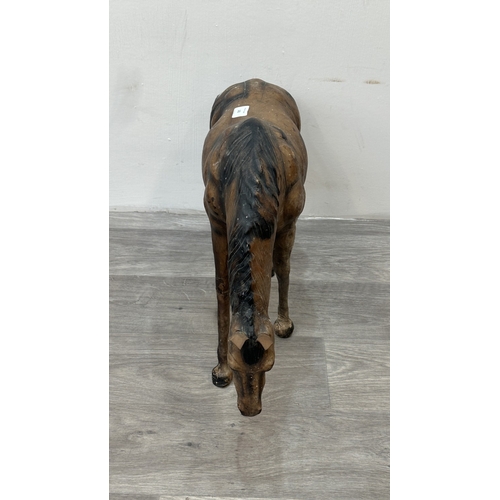 142 - A Liberty & Co. style leather model of a grazing horse - approx. 39cm high x 59cm long