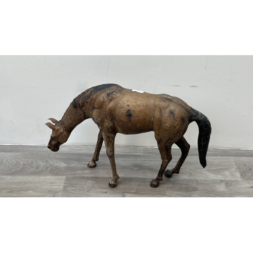 142 - A Liberty & Co. style leather model of a grazing horse - approx. 39cm high x 59cm long