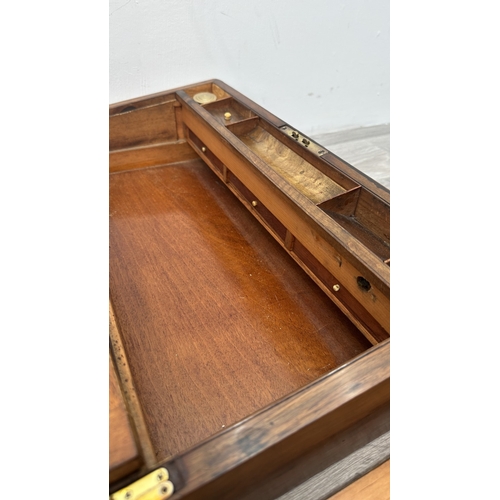147 - A 19th century inlaid walnut and oak crossbanded writing slope with fitted interior and two glass in... 