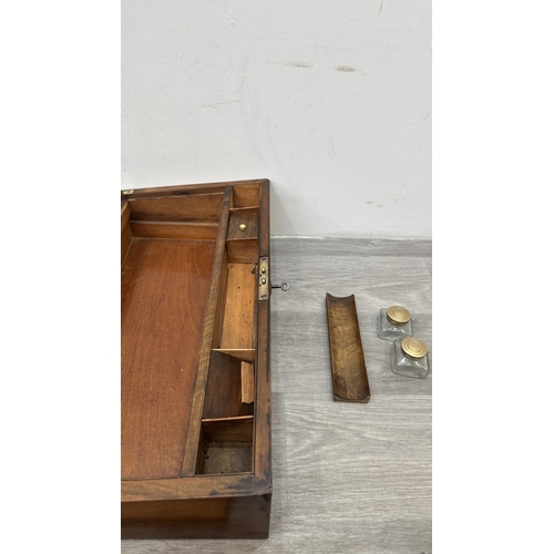 147 - A 19th century inlaid walnut and oak crossbanded writing slope with fitted interior and two glass in... 