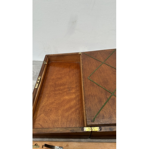 147 - A 19th century inlaid walnut and oak crossbanded writing slope with fitted interior and two glass in... 