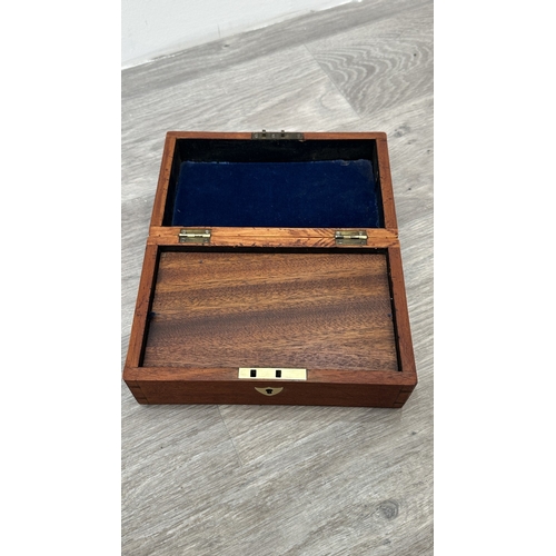 148 - Four items, one Chinese red lacquered wooden jewellery cabinet with brass decoration and carved cork... 