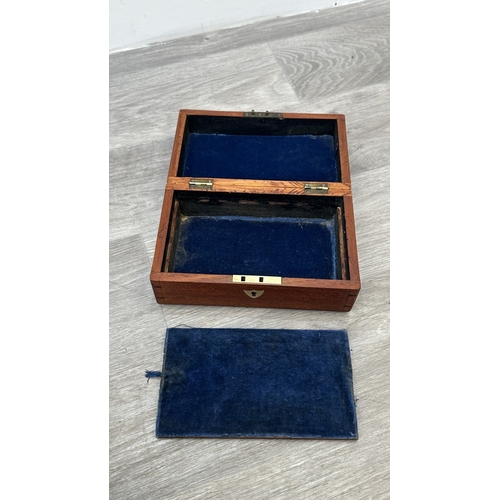 148 - Four items, one Chinese red lacquered wooden jewellery cabinet with brass decoration and carved cork... 