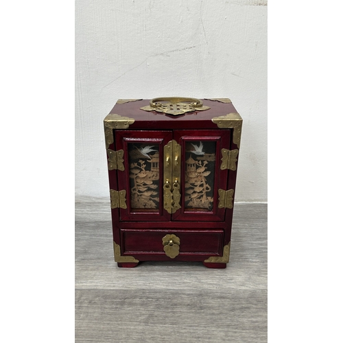 148 - Four items, one Chinese red lacquered wooden jewellery cabinet with brass decoration and carved cork... 