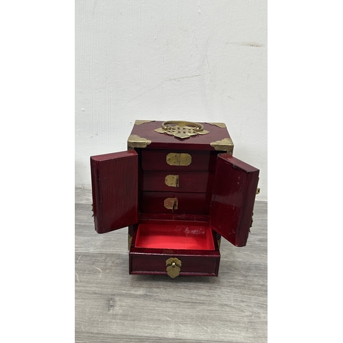 148 - Four items, one Chinese red lacquered wooden jewellery cabinet with brass decoration and carved cork... 