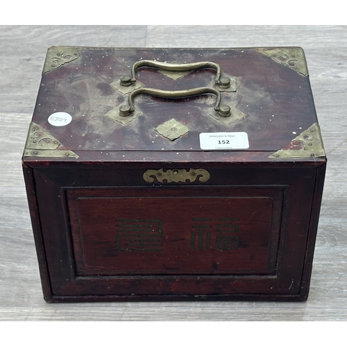 152 - An early 20th century Chinese stained wooden and brass cased mahjong set featuring one hundred and f... 