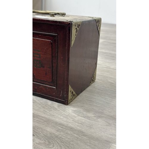 152 - An early 20th century Chinese stained wooden and brass cased mahjong set featuring one hundred and f... 