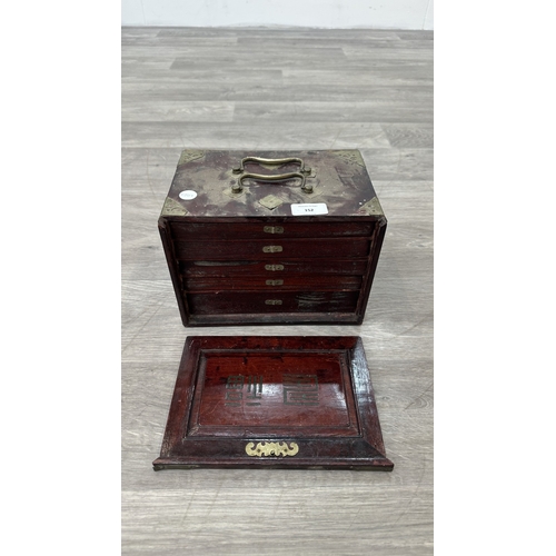 152 - An early 20th century Chinese stained wooden and brass cased mahjong set featuring one hundred and f... 