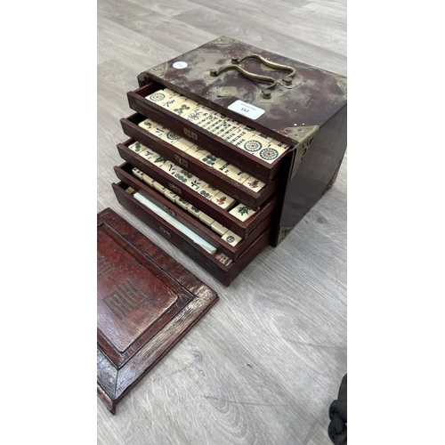 152 - An early 20th century Chinese stained wooden and brass cased mahjong set featuring one hundred and f... 