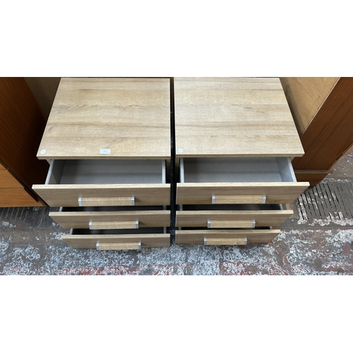 155 - A pair of modern oak effect bedside chests of drawers - approx. 50cm high x 48cm wide x 42.5cm deep