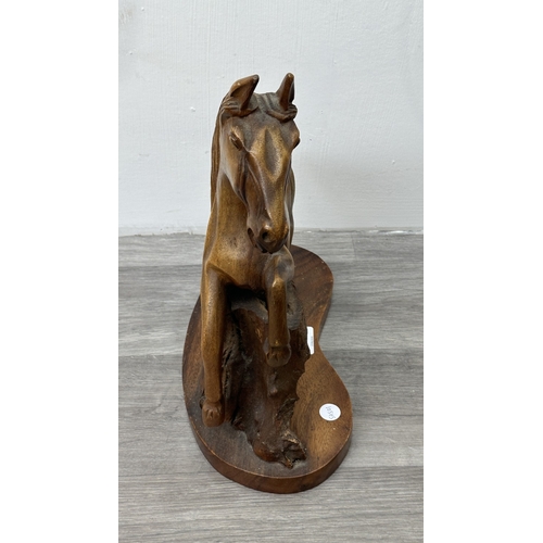 159 - A mid 20th century hand carved wooden horse sculpture - approx. 36cm high x 30cm wide