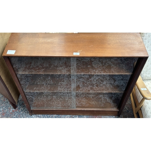 162 - A mid 20th century Herbert E. Gibbs teak bookcase with two glass sliding doors - approx. 83cm high x... 