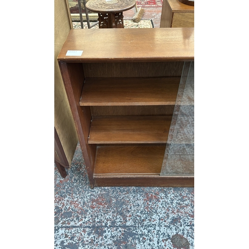 162 - A mid 20th century Herbert E. Gibbs teak bookcase with two glass sliding doors - approx. 83cm high x... 