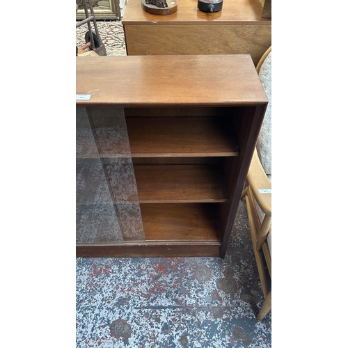162 - A mid 20th century Herbert E. Gibbs teak bookcase with two glass sliding doors - approx. 83cm high x... 