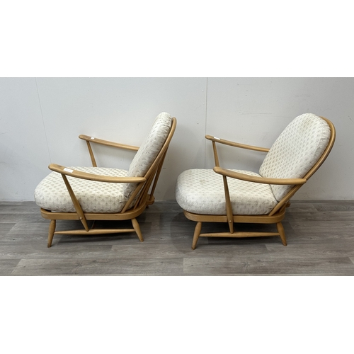 163 - A pair of mid 20th century Ercol Windsor Model 203 blonde beech armchairs with cream fabric upholste... 
