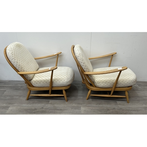 163 - A pair of mid 20th century Ercol Windsor Model 203 blonde beech armchairs with cream fabric upholste... 
