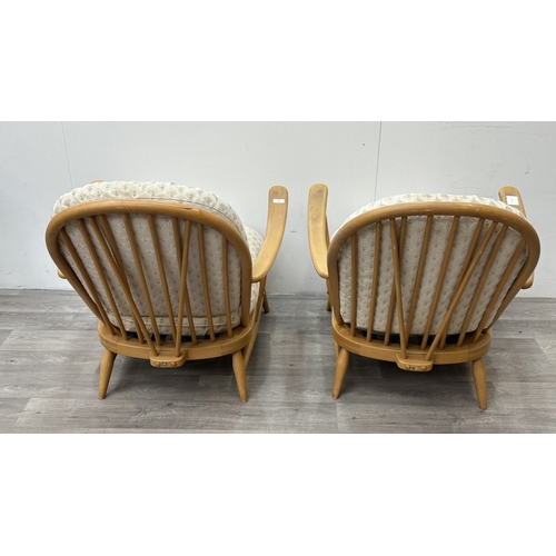 163 - A pair of mid 20th century Ercol Windsor Model 203 blonde beech armchairs with cream fabric upholste... 