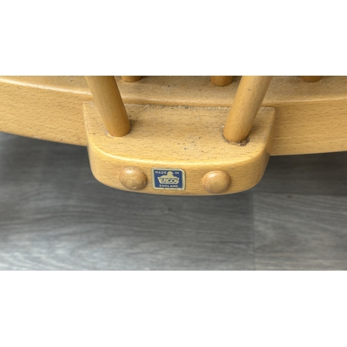 163 - A pair of mid 20th century Ercol Windsor Model 203 blonde beech armchairs with cream fabric upholste... 