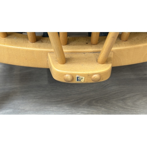 163 - A pair of mid 20th century Ercol Windsor Model 203 blonde beech armchairs with cream fabric upholste... 