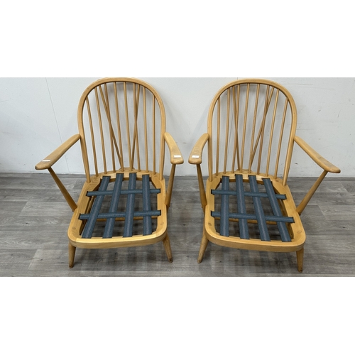 163 - A pair of mid 20th century Ercol Windsor Model 203 blonde beech armchairs with cream fabric upholste... 