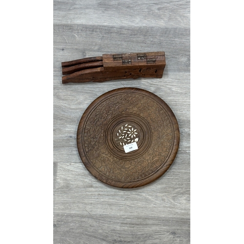 168 - An Indian inlaid and carved teak circular folding side table with floral design - approx. 31cm high ... 