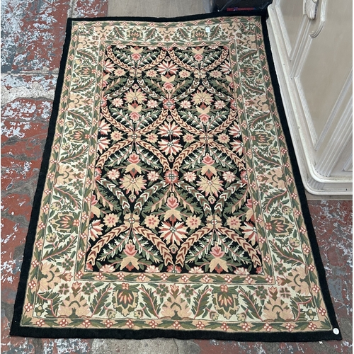 173 - An Arts & Crafts style William Morris type floral embroidered rug - approx. 165cm x 106cm