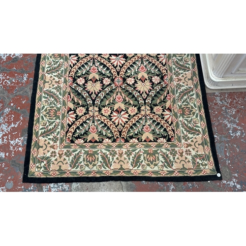 173 - An Arts & Crafts style William Morris type floral embroidered rug - approx. 165cm x 106cm