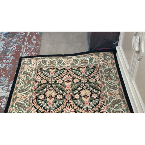 173 - An Arts & Crafts style William Morris type floral embroidered rug - approx. 165cm x 106cm