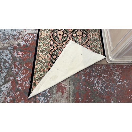 173 - An Arts & Crafts style William Morris type floral embroidered rug - approx. 165cm x 106cm