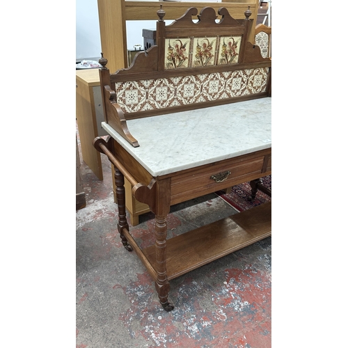 177 - An Edwardian walnut and marble top washstand with ceramic tile splashback - approx. 121cm high x 120... 