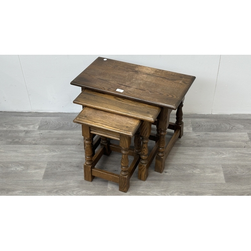 178 - A Wood Bros 'Old Charm' oak joint nest of three tables - approx. 45cm high x 60cm wide x 32cm deep