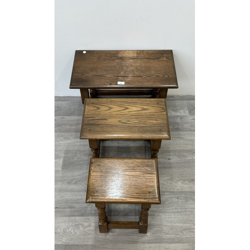 178 - A Wood Bros 'Old Charm' oak joint nest of three tables - approx. 45cm high x 60cm wide x 32cm deep