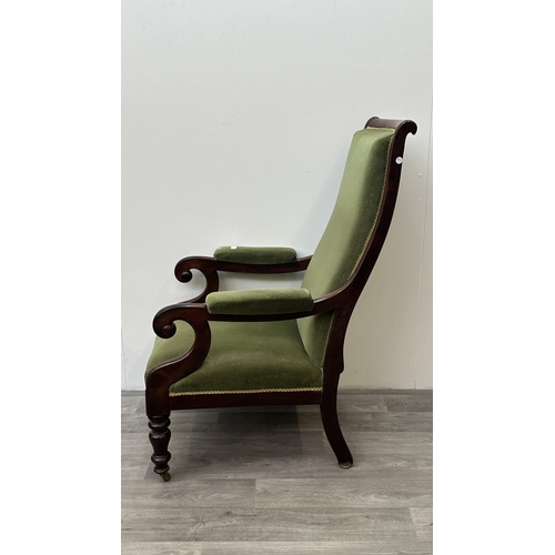 180 - A 19th century rosewood and green fabric upholstered scrolled armchair on brass castors - approx. 11... 