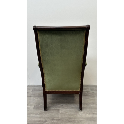 180 - A 19th century rosewood and green fabric upholstered scrolled armchair on brass castors - approx. 11... 