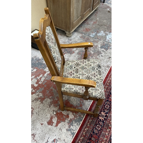 182 - A Wood Bros 'Old Charm' oak draw leaf dining table on carved baluster supports and six tapestry upho... 